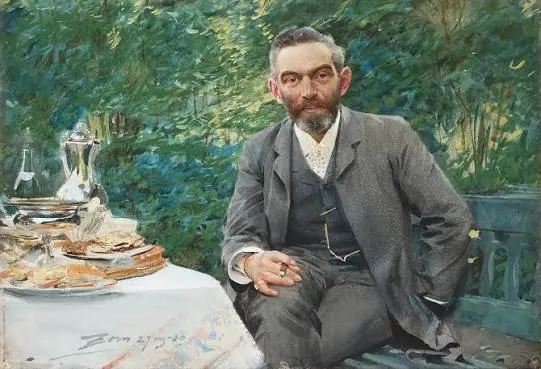 A man at a garden table set with silver